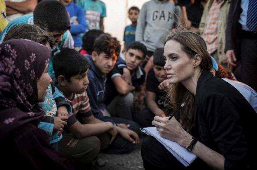 Angelina Jolie in her role as UN convoy speaking with refugee children 