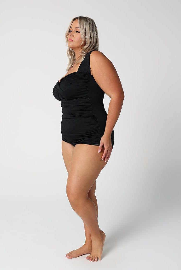 Woman wearing a black swimsuit on a white background