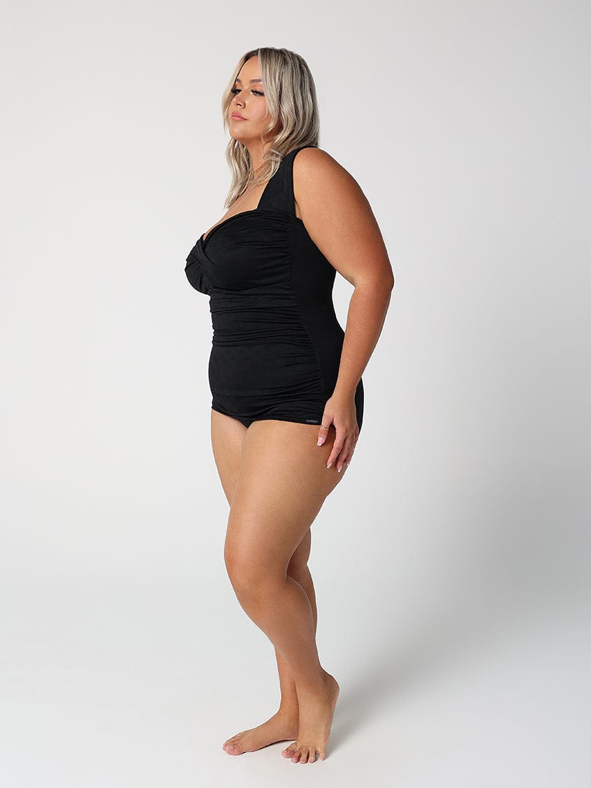 Woman wearing a black swimsuit on a white background