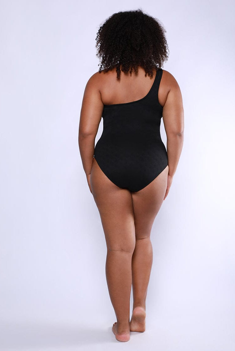 Person wearing a black bodysuit on a white background