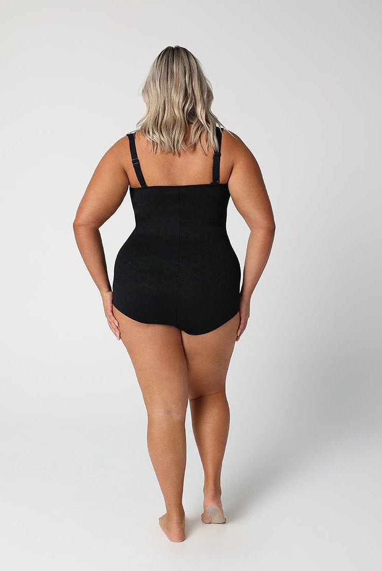 Person wearing a black swimsuit on a white background