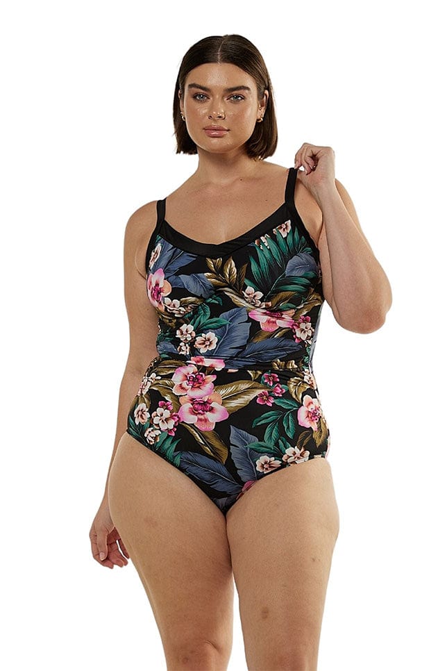 brunette model wearing black floral underwire one piece swimwear
