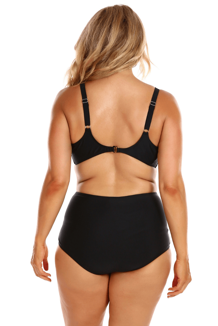 Person wearing a black bikini set on a white background