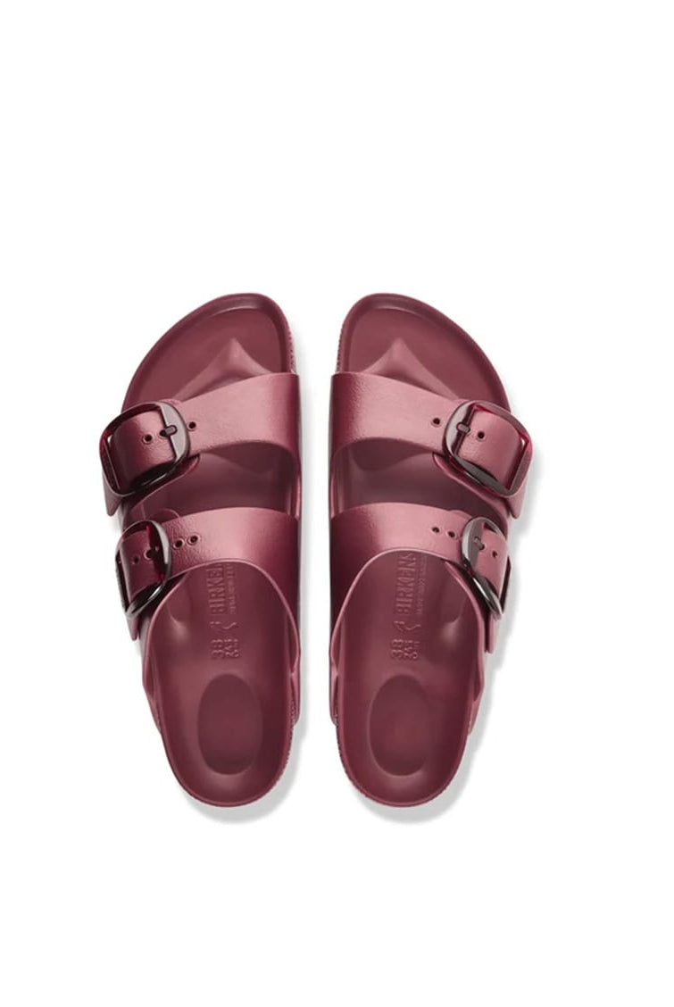 A pair of burgundy double-strap slide sandals with silver buckle details, shown from a top-down view on a white background.