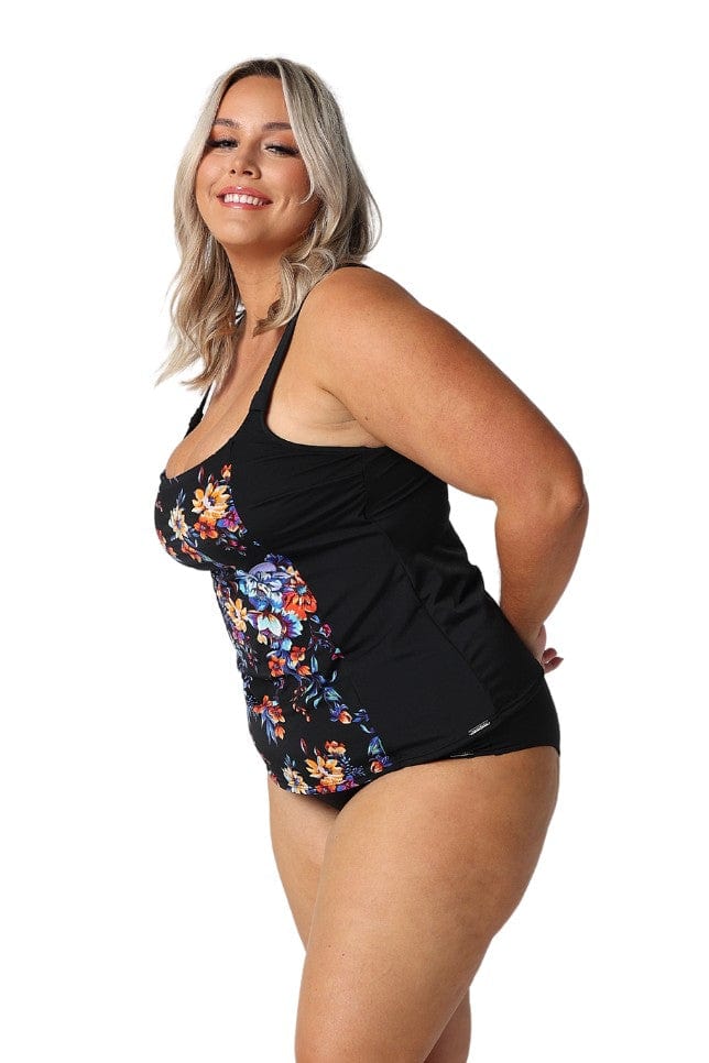 Model showing side of floral tankini top and black pants