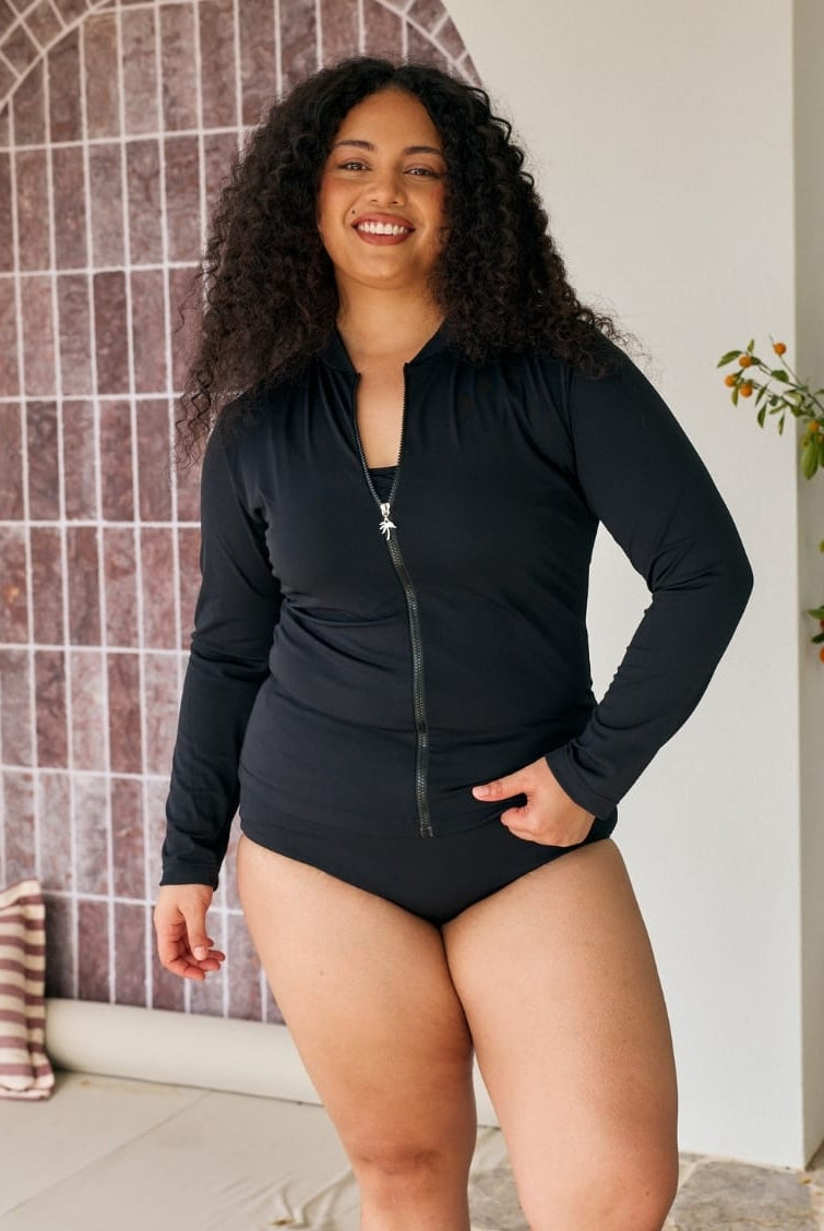 Model wearing a black long sleeve sun safe rashie in chlorine resistant