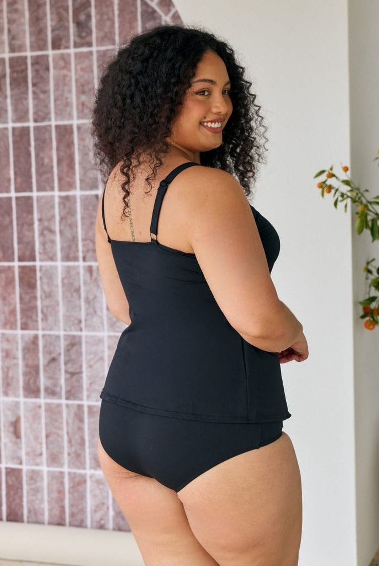 Back of model showing off black chlorine resistant tank tankini top with adjustable straps