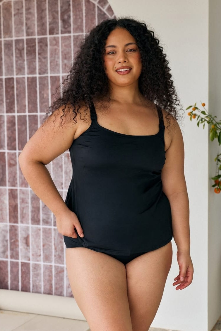 Model in black chlorine resistant tank tankini top