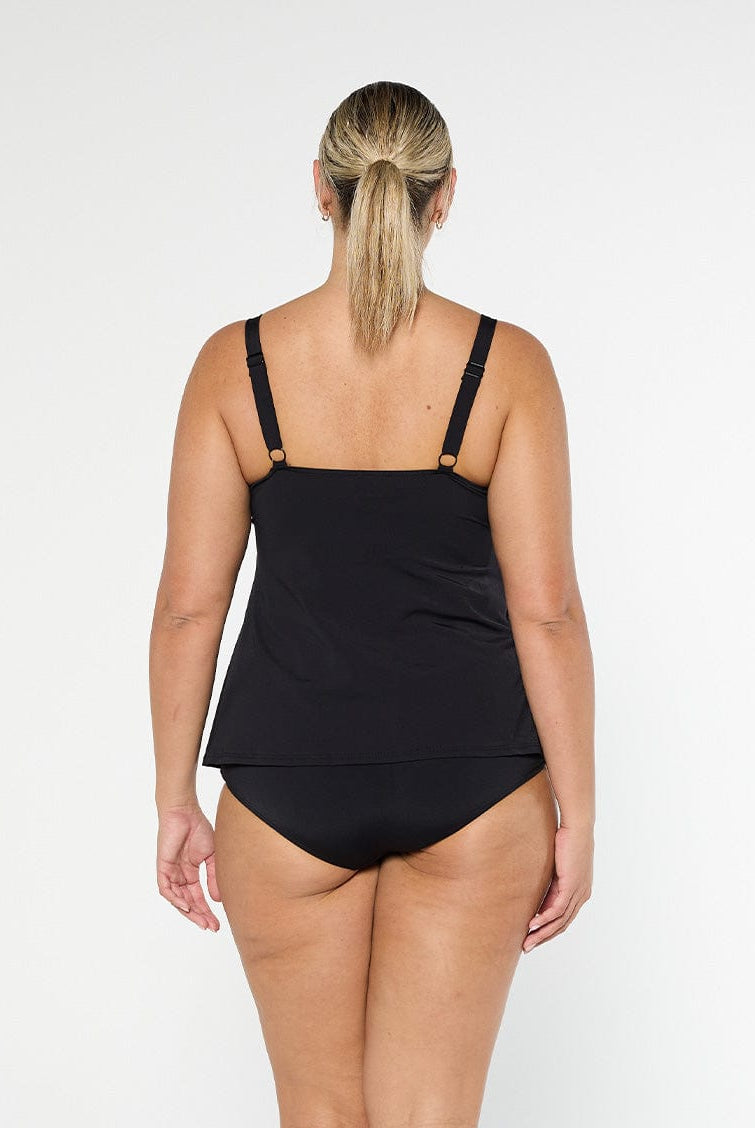 Blonde model shows the back of black pool proof tankini top with adjustable straps