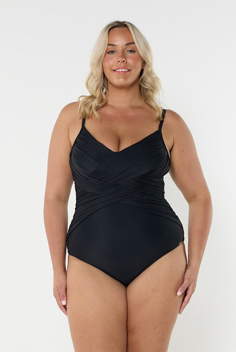 Blonde model wearing black criss cross one piece
