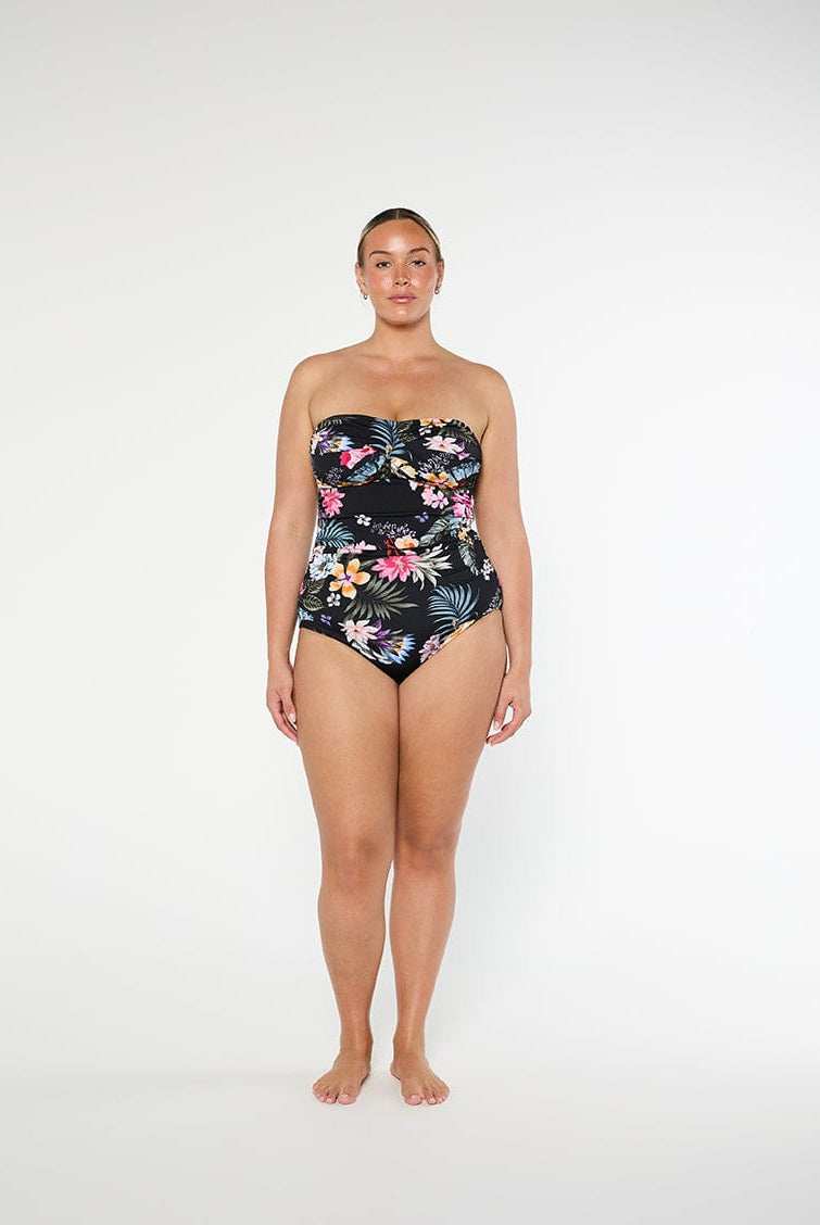 Woman wearing a strapless floral swimsuit on a white background