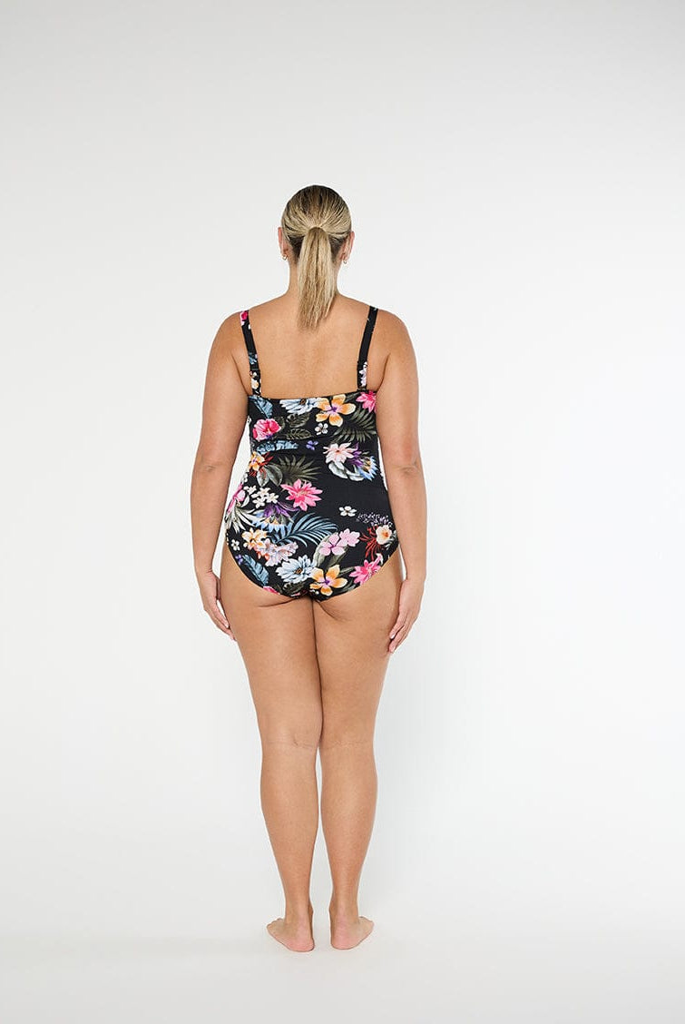 Woman wearing a floral swimsuit on a white background