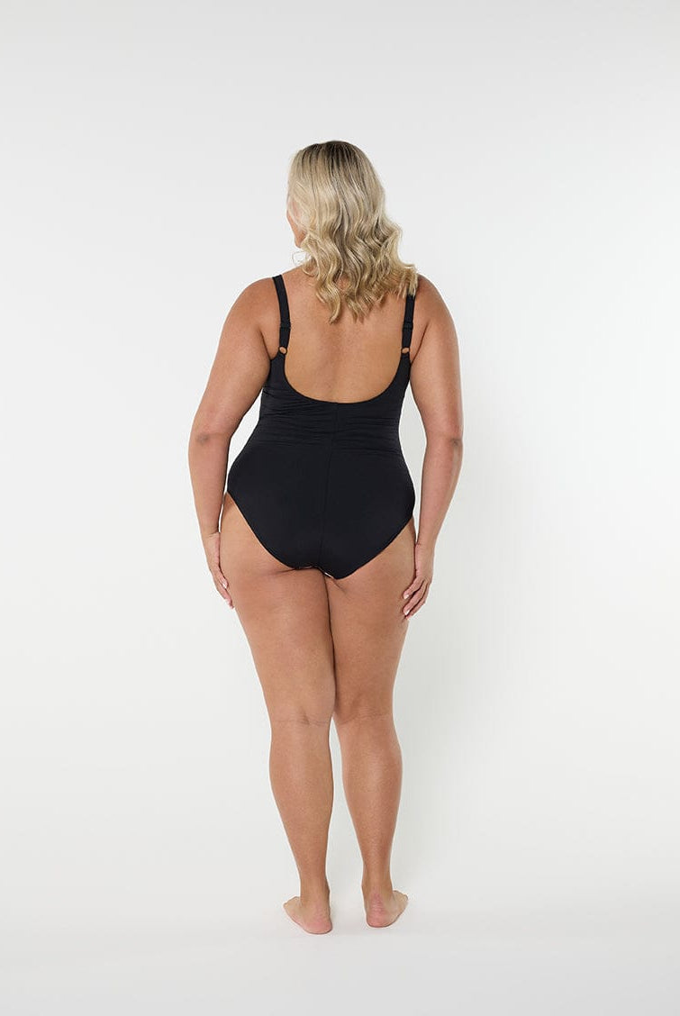Person wearing a black swimsuit on a white background