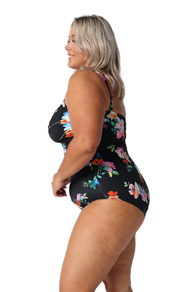 Model showing side of black floral swimsuit