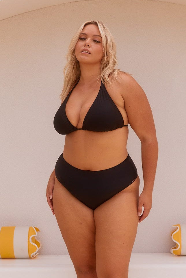 Blonde model wearing black high rise bikini bottoms