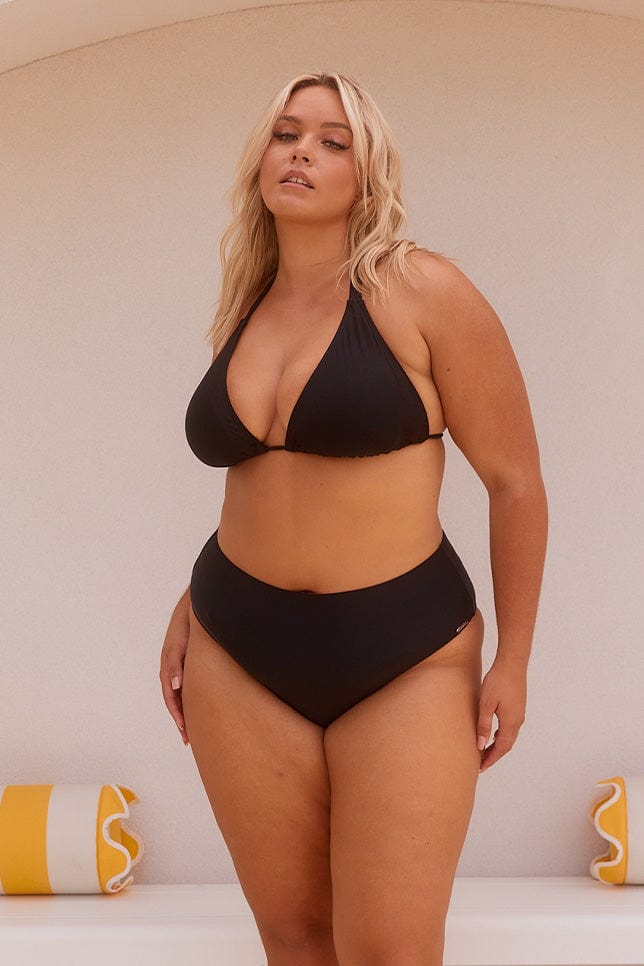 Blonde model wearing black high rise bikini bottoms