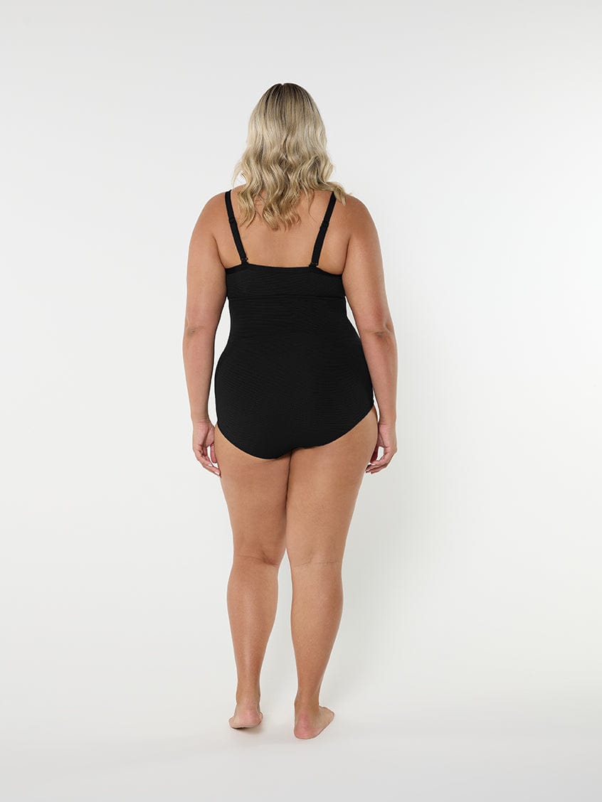 Person wearing a black swimsuit on a white background