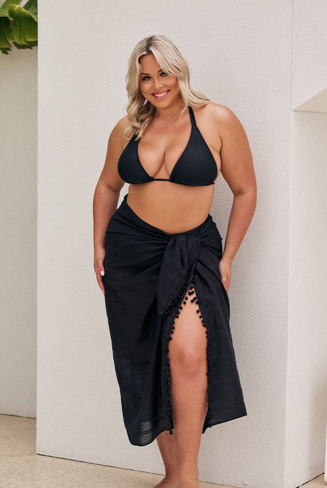 Blonde model wears long black sarong