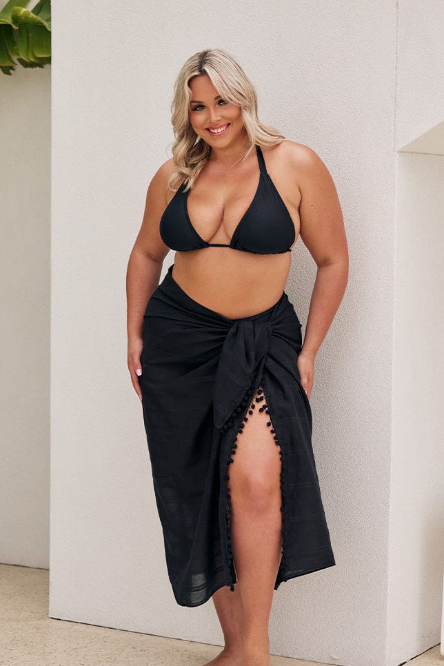 Blonde model wears long black sarong