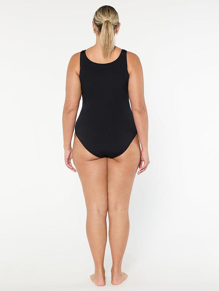 Person wearing a black swimsuit on a white background
