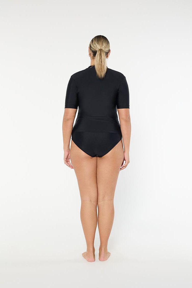 Person wearing a black swimsuit on a white background