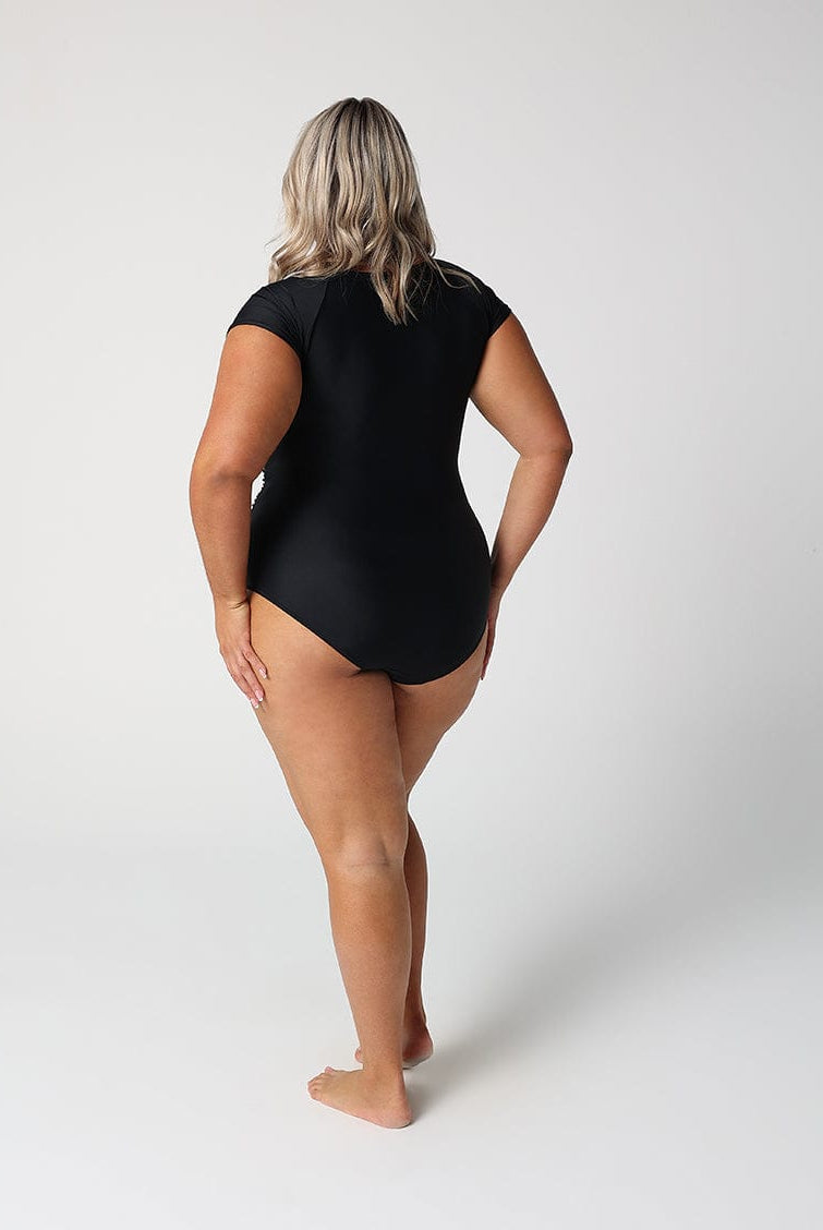 Person wearing a black swimsuit on a white background