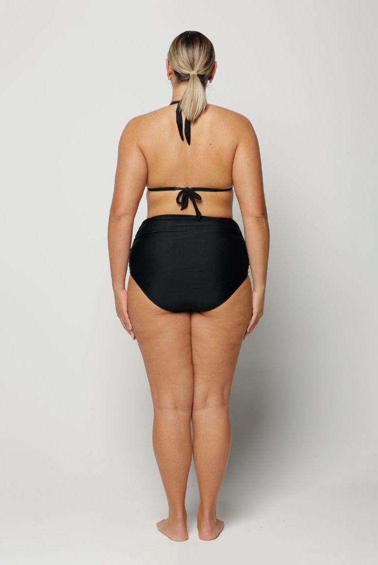 Person wearing a black bikini on a white background
