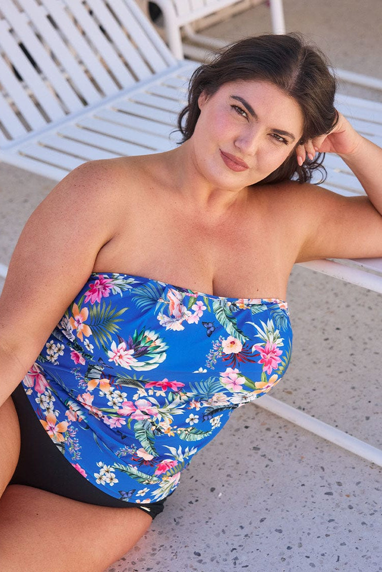 Brunette model wears stunning blue floral bandeau tankini top with removable straps