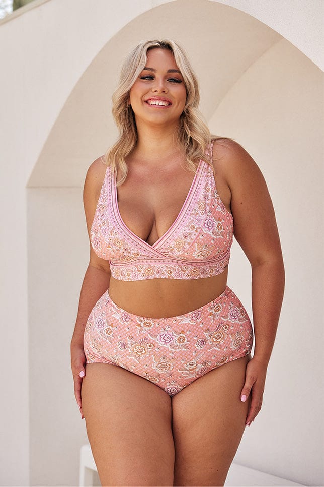 Blonde model wearing blush pink floral high waisted bottoms