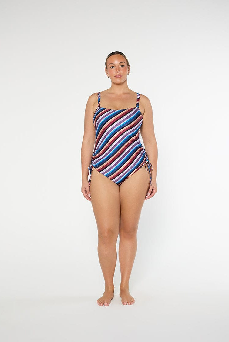 Woman wearing a striped swimsuit on a white background