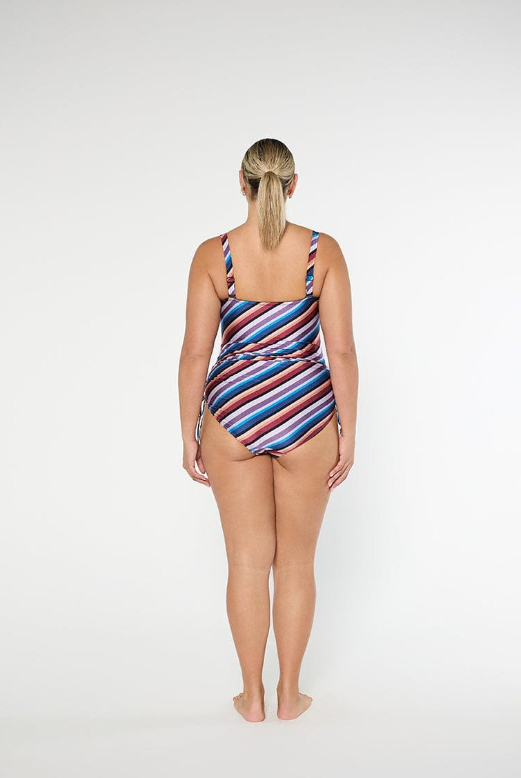 Woman wearing a striped swimsuit on a white background