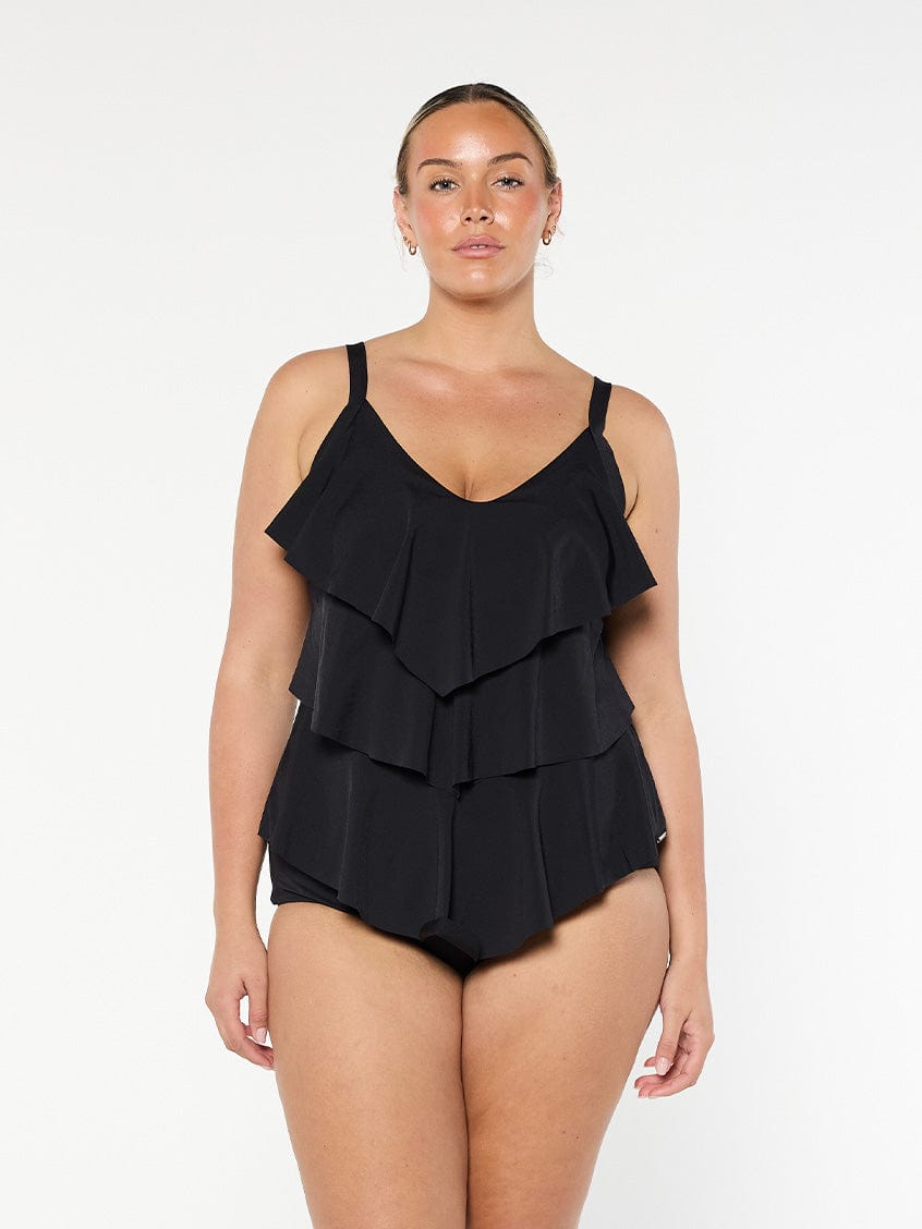 Blonde model wears black chlorine resistant tankini top