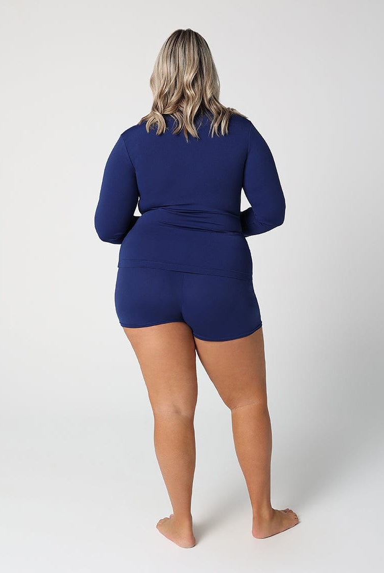 Person wearing a blue swimsuit on a white background