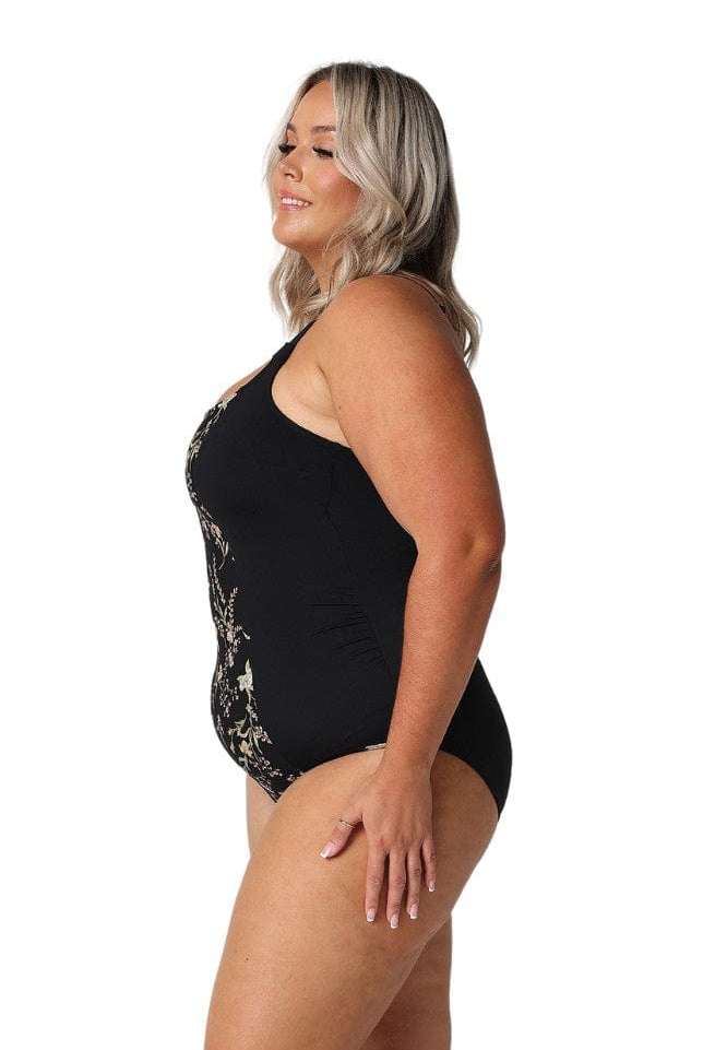 Model showing side of black floral tank one piece swimsuit