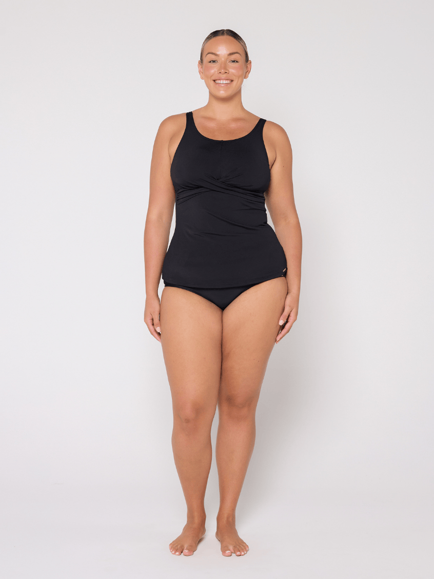 Person wearing a black swimsuit on a white background