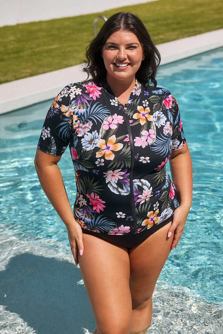 Woman wearing a floral swimsuit by a pool