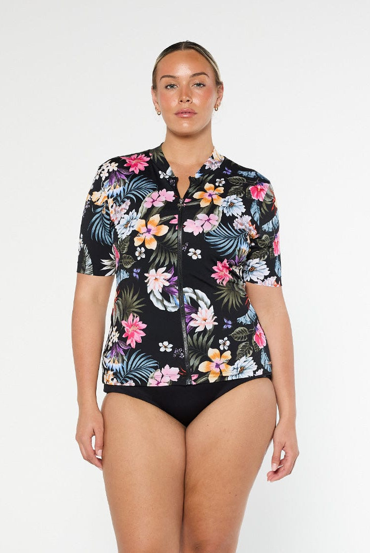 Blonde model shows front of chlorine resistant short sleeve rashie in black floral print