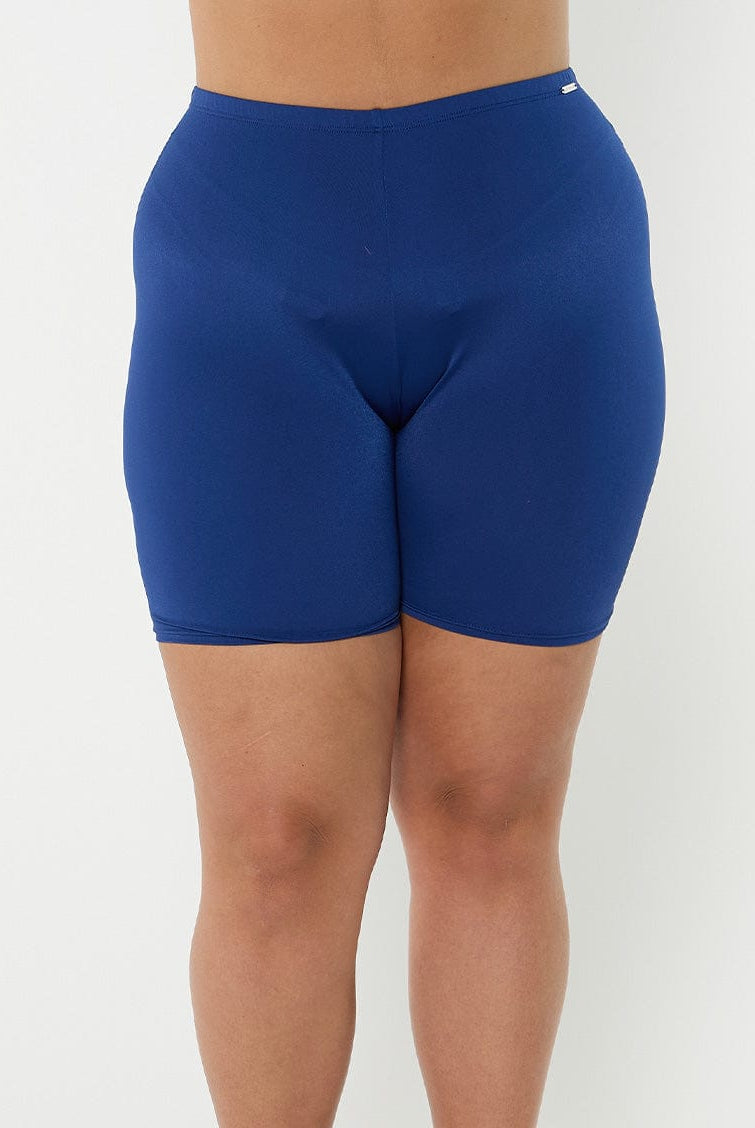 Front of model in studio wearing high waisted navy bike pant