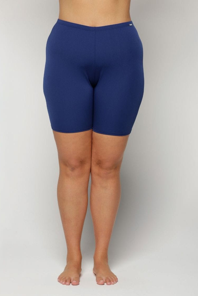 Navy blue chlorine resistant curvy shorts worn by a person on a plain background