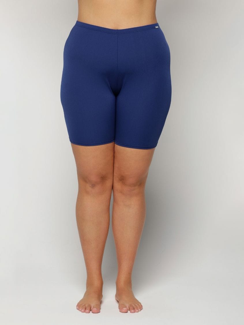 Navy blue chlorine resistant curvy shorts worn by a person on a plain background