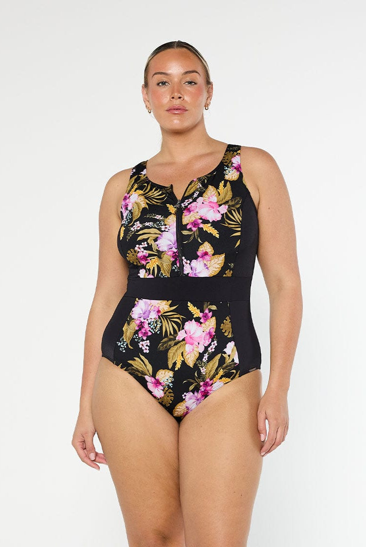 Blonde model wears sleeveless chlorine resistant pink floral one piece with front zip