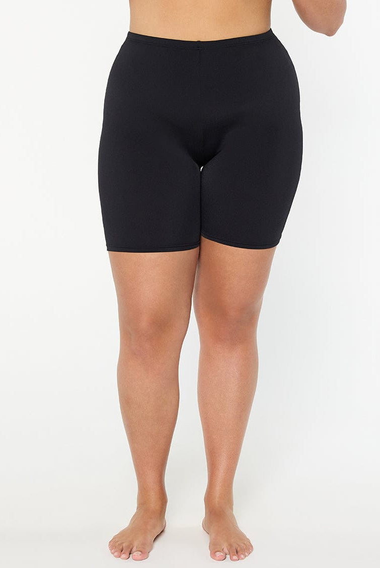 Person wearing black shorts on a white background
