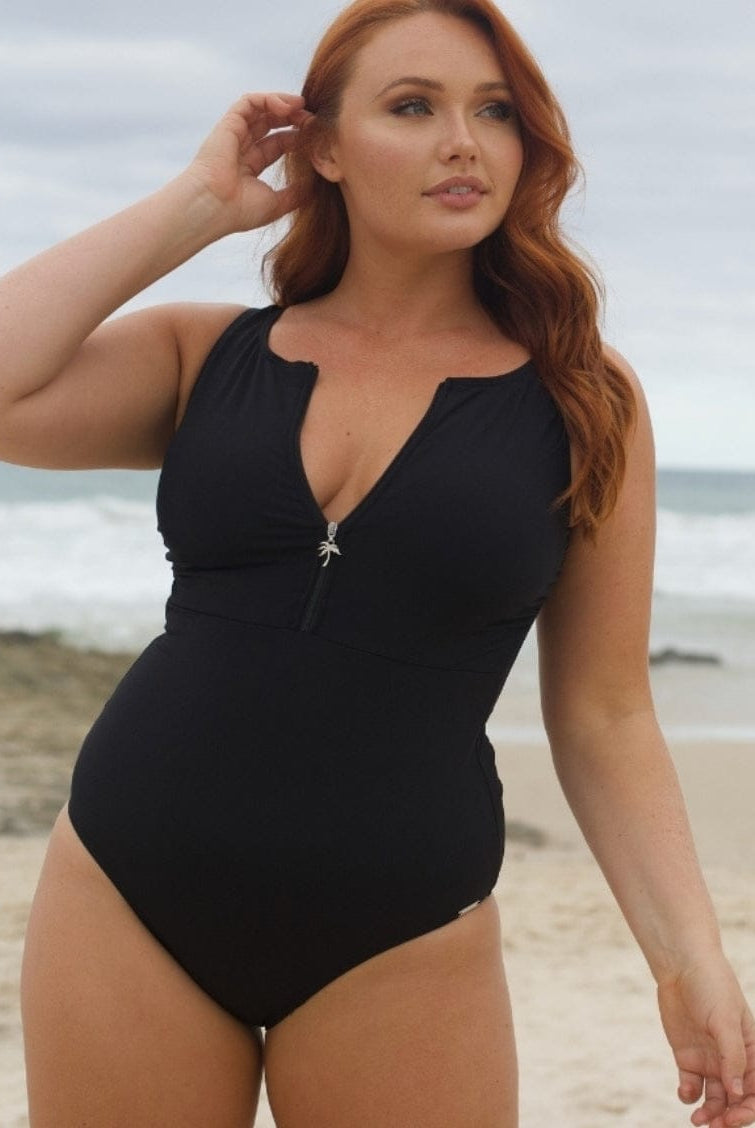 Woman wearing a black swimsuit on a beach