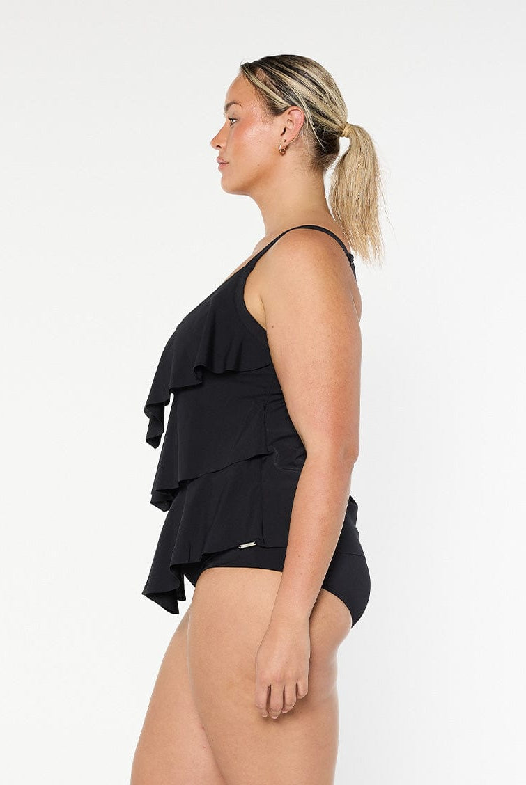 Blonde model wears black 3 tier ruffle tankini top in chlorine resistant fabric