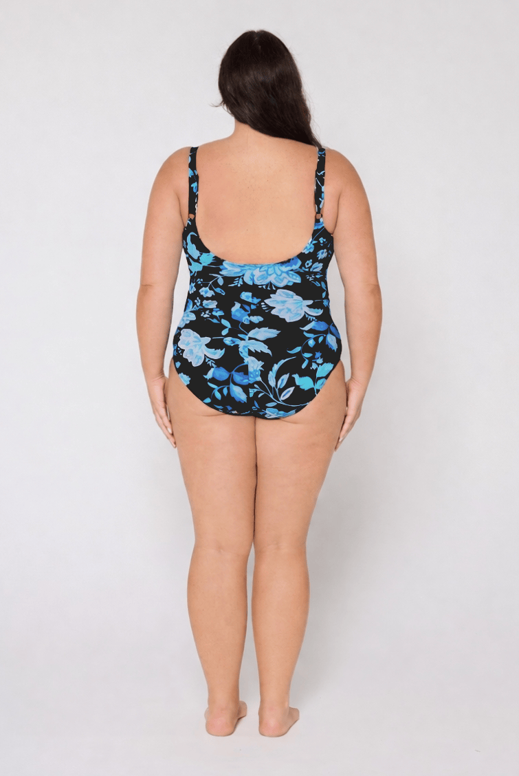 Woman wearing a floral swimsuit on a white background