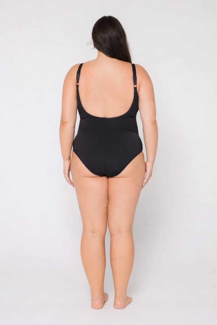 Woman wearing a black swimsuit on a white background