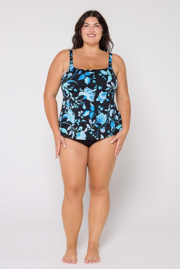 Woman wearing a floral-patterned swimsuit top on a white background