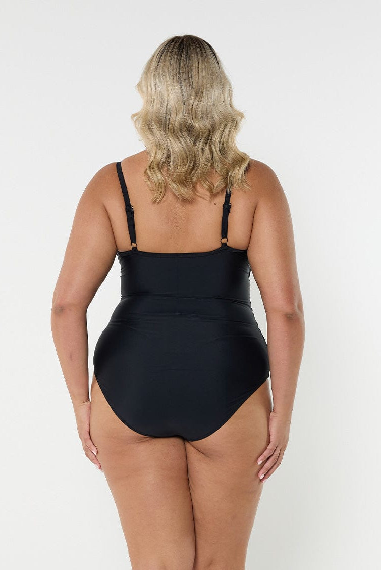 Blonde model showing back of black criss cross one piece