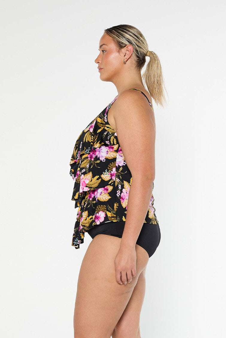 Blonde model shows the side of pink floral chlorine resistant ruffled tankini top with adjustable straps