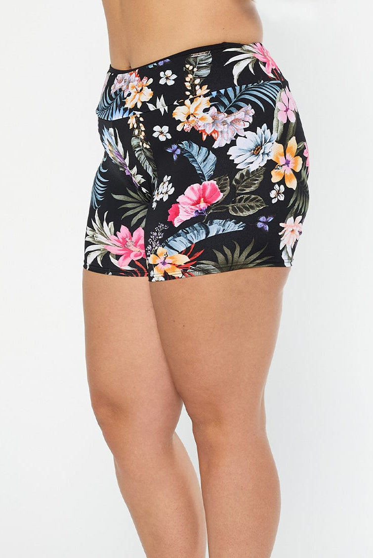 model shows side of full coverage boyleg pant in black floral chlorine resistant fabric